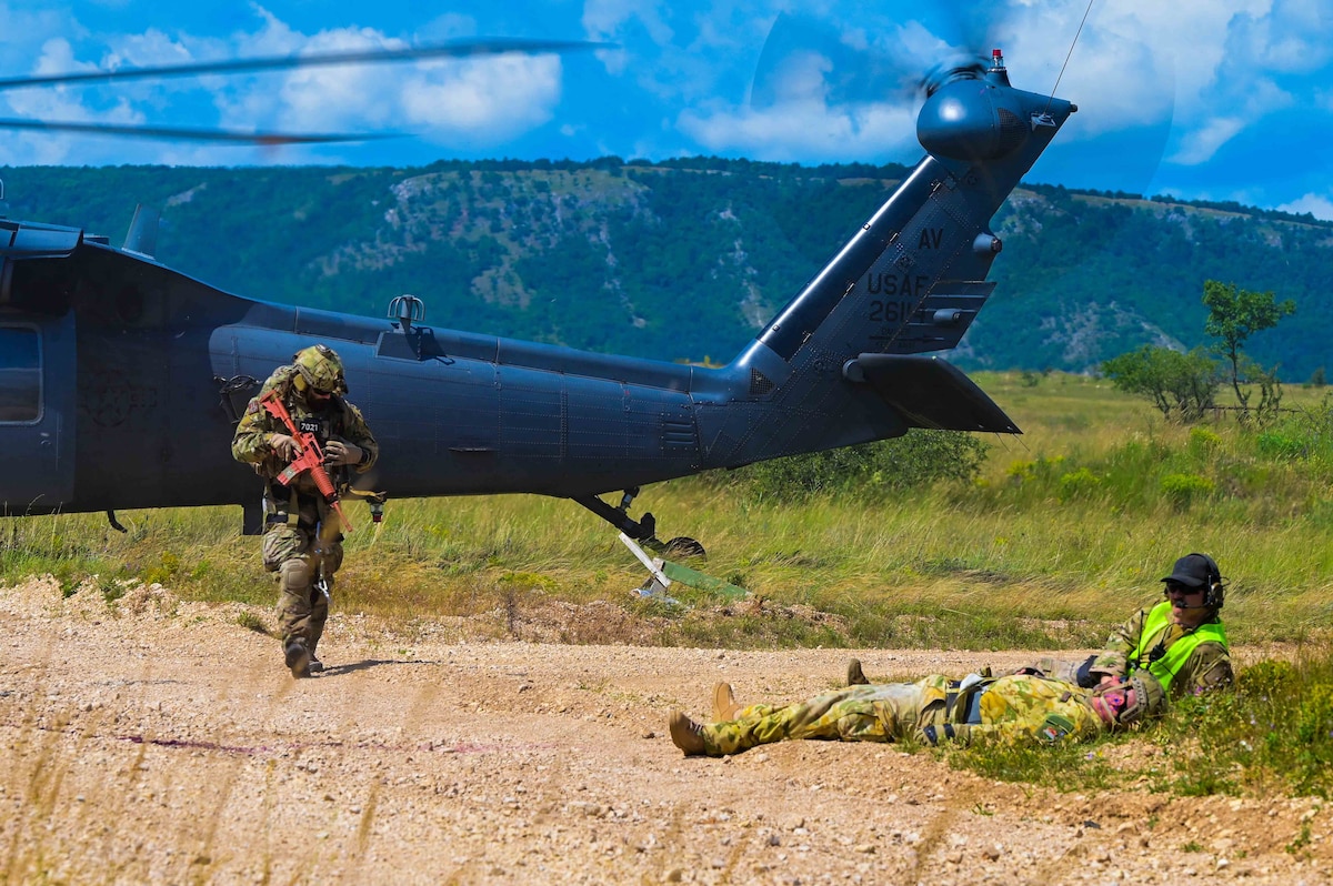 A Norwegian flight medic responds to a survivor during exercise Jolly Vihar at a training range