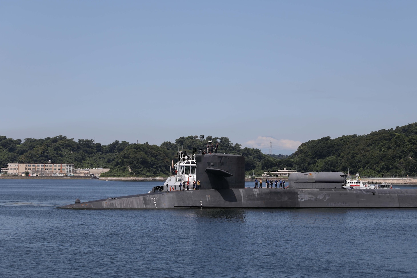 The Ohio-class guided-missile submarine USS Michigan (SSGN 727) arrives in Fleet Activities Yokosuka, July 2, 2023. Homeported in Naval Base Kitsap, Bangor, Washington, Michigan provides strike and special operation mission capabilities from a stealthy, clandestine platform.