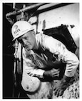 A USCG Marine Inspector checks on the boiler of a U.S. merchant vessel.