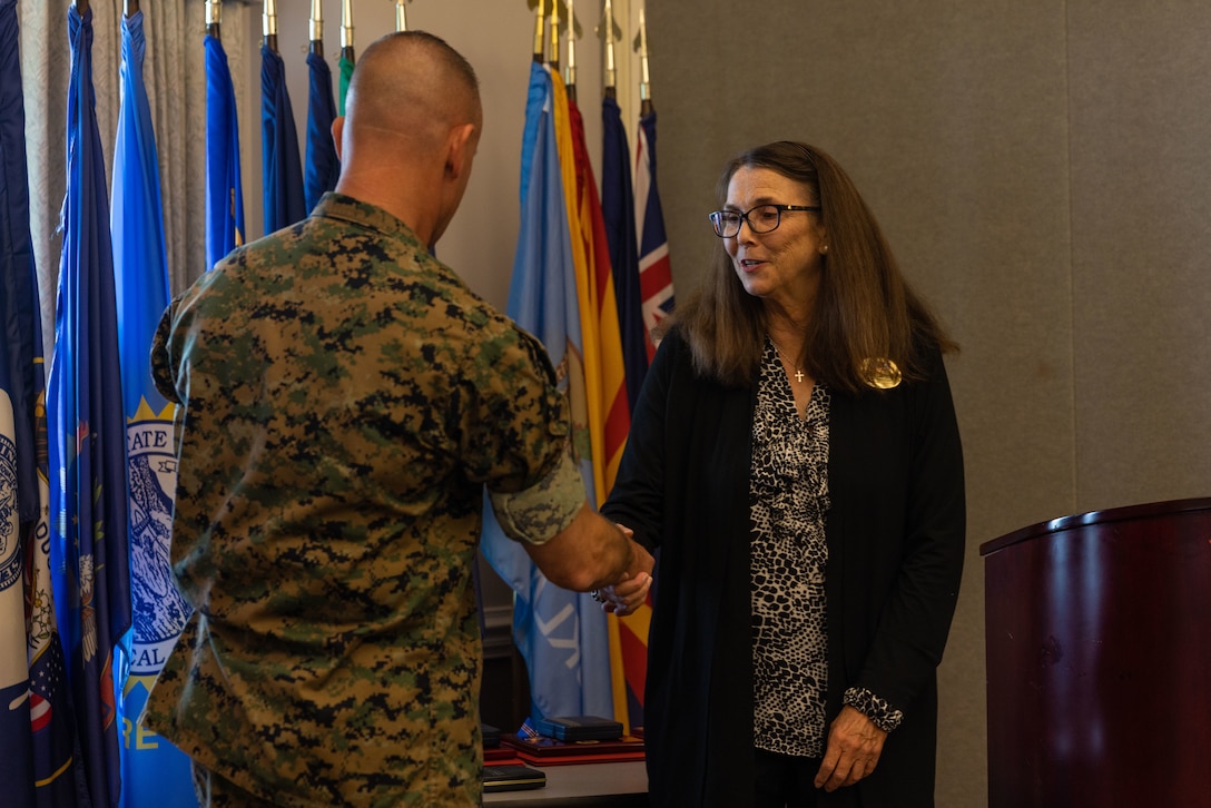 U.S. Marine Corps Air Station (MCAS) Cherry Point Commanding Officer Col. Brendan Burks congratulates Vera Campbell, Marine and Family Program director, during the Civilian of the Year award ceremony at Miller’s Landing, MCAS Cherry Point, North Carolina, June 5, 2023. The ceremony spotlighted six total awardees from various departments on the installation who exceeded performance expectations to serve the MCAS Cherry Point community and beyond. (U.S. Marine Corps photo by Cpl. Jade Farrington)