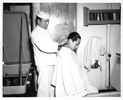 USCG Barber provides a haircut to a fellow Coast Guardsman