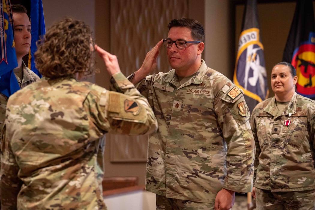 Maj. Thomas W. Uhl salutes Col. Sirena I. Morris