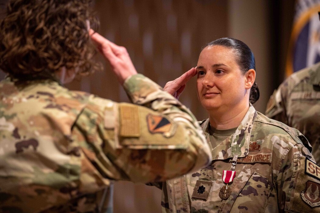 Lt. Col. Nicole M. Schatz salutes Col. Sirena I. Morris