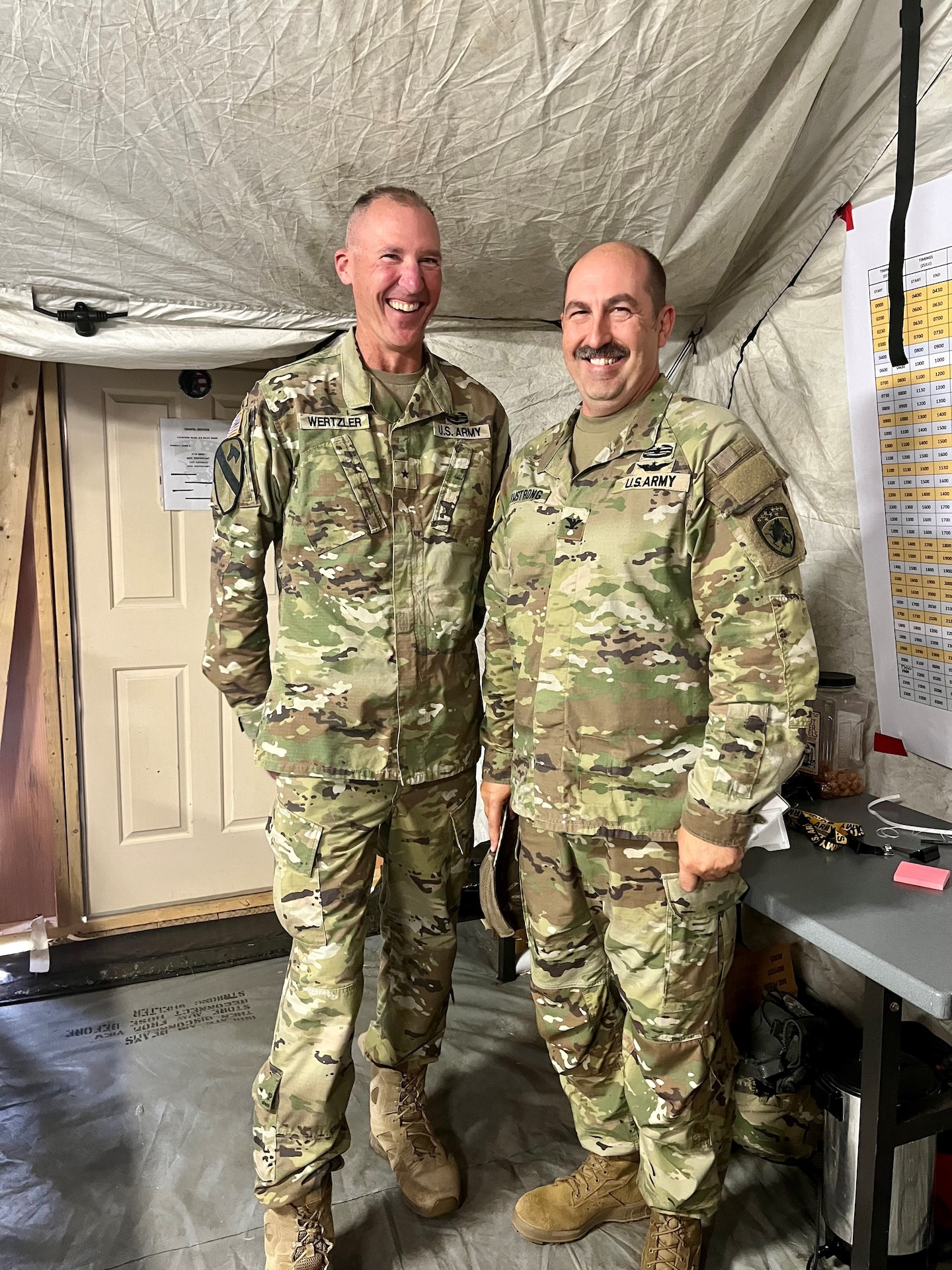Brig. Gen. Brian Wertzler and Col. Mike Armstrong stop for a picture during a senior leader visit to the 63rd tactical operations post. The 63rd TAB participated in warfighter 23-05 as a combat aviation brigade supporting the III Corps.