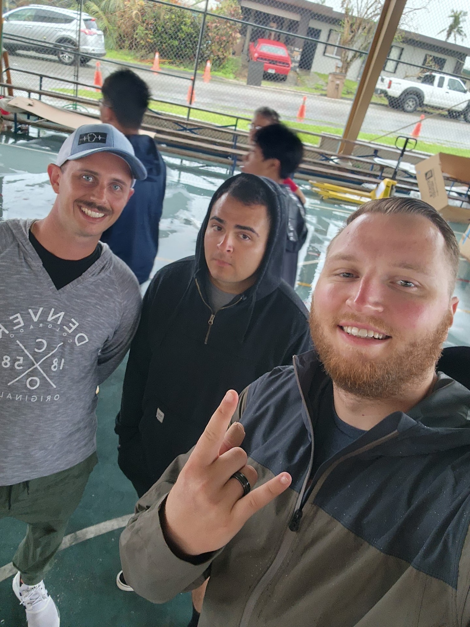 From left to right, U.S. Air Force Tech. Sgt. Mark Eastman, 51st Logistics Readiness Squadron (LRS) fuels distribution non-commissioned officer in charge (NCOIC); Staff Sgt. Angel Rebollar, 51st LRS fuels laboratory NCOIC, and Staff Sgt. Lucas Amodeo, 51st LRS fuels mobile distribution supervisor, pose for a photo during Typhoon Mawar recovery operations near Andersen Air Force Base, Guam. These three Airmen assisted the Red Cross in delivering aid to remote villages by visiting 1,300 families and distributing over 103,000 pounds of aid. (Courtesy photo)