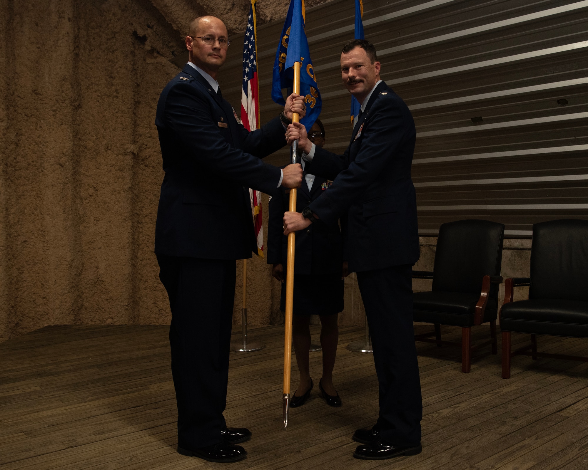 A Lt. Col. and a Col. holds a guidon