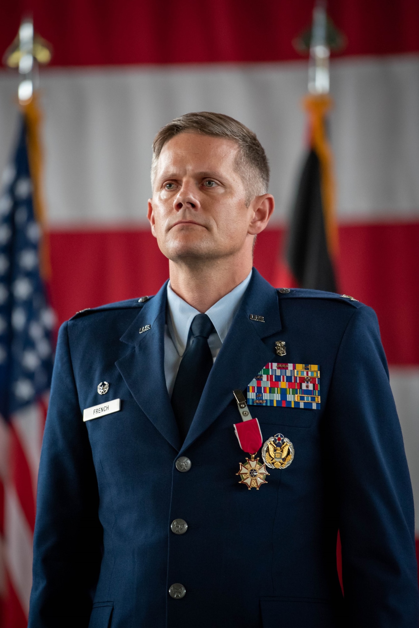 U.S. Air Force Col. Peter French 52nd Medical group outgoing commander, stands at attention after rendering a final salute to members of the 52nd MDG during a change of command ceremony June 30, 2023, on Spangdahlem Air Base, Germany.