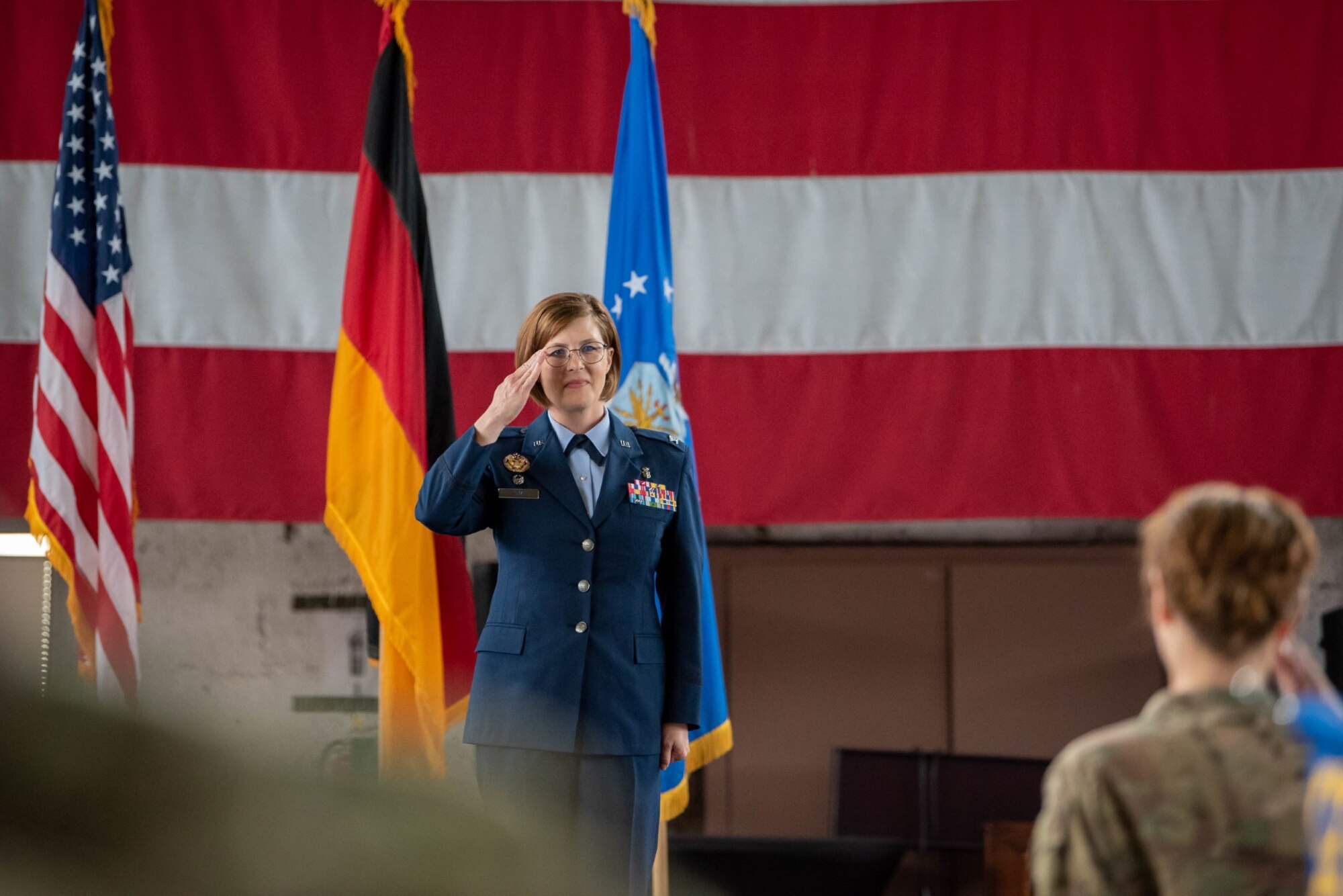U.S. Air Force Col. Karri Roman, 52nd Medical Group incoming commander, renders her first salute during the 52nd MDG change of command ceremony June 30, 2023, on Spangdahlem Air Base, Germany.