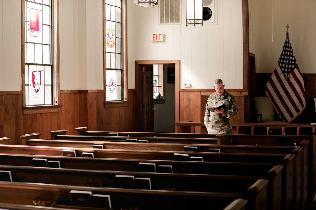 Col. William Draper, chaplin, Kentucky Army National Guard, prepares to deliver a sermon for attendees of the Cyber Shield Training exercise at the Camp Robinson chapel, Little Rock Ark., June 2-16, 2023. More than 800 National Guard Soldiers, Airmen, and civilian cyber professionals from around the world gather during this year’s Cyber Shield Training exercise. More than 25 states and territories will participate in the event and will make a signifiacnt milestone as members from five State Partnership Programs join forces with the National Guard cyber teams for the first time during the event. (Kentucky National Guard photo by Staff Sgt. Jeffery Reno)