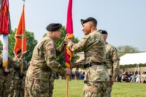 Phot of Col. James L. Crocker (left) receiving the Tobyhanna Army Depot flag from Maj. Gen. Robert L. Edmonson II (right), signifying his assumption of command of Tobyhanna Army Depot.