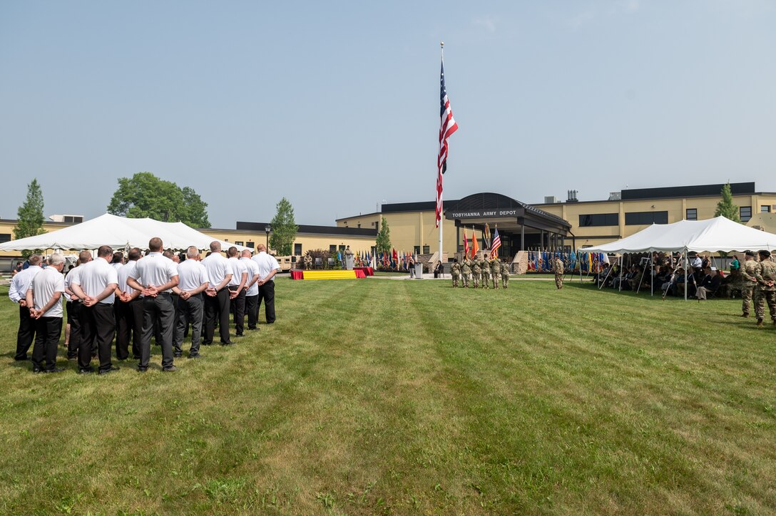 Photo of A Civilian Honor Guard, Color Guard, Troop Formation, invited guests and the depot workforce looking on during the Change of Command ceremony.