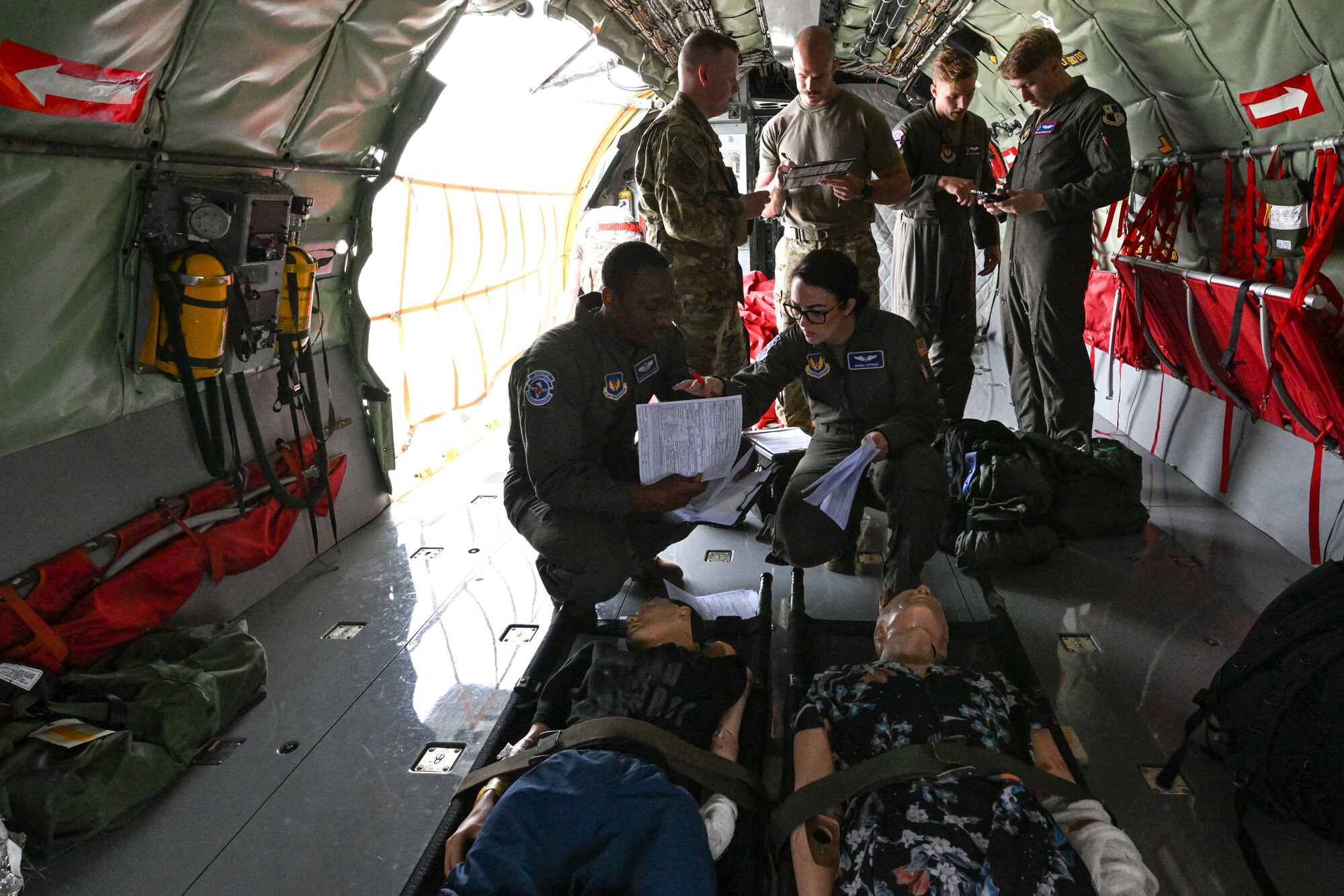 Service members review training and flight plans.