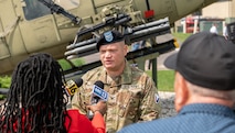 Photo of Col Crocker being interviewed by the press