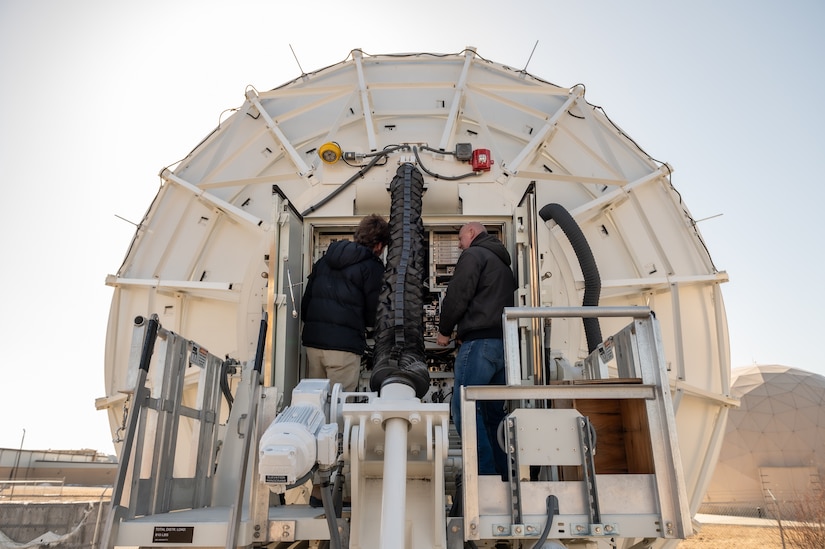 Photo of Personnel at Tobyhanna Army Depot making adjustments to the first Hardened Transportable Terminal – Modified, which was a new design and fabrication effort for the depot.