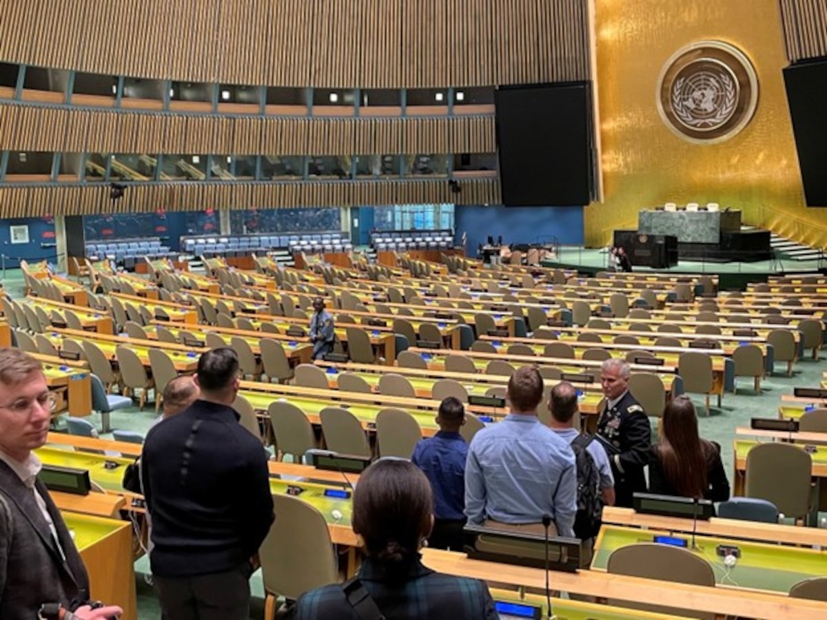 Photo of people walking through the UN General Assembly.