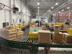 Boxes on a conveyor belt in a warehouse.