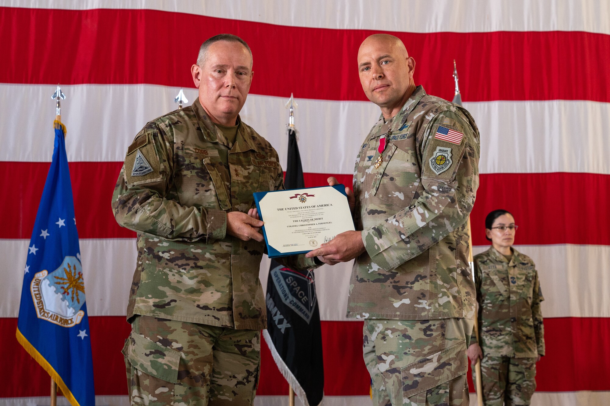 U.S. Air Force Maj. Gen. Patrick Cobb, Air National Guard Assistant to the Commander, Space Operations Command, (left) presents U.S. Space Force Col. Christopher Fernengel, outgoing Space Delta 3 commander, (right) with the Legion of Merit during DEL 3’s change of command ceremony June 29, 2023, at Peterson Space Force Base. The Legion of Merit was given to Fernengel for exceptionally meritorious conduct in the performance of outstanding service to the U.S. as commander of DEL 3. (U.S. Space Force photo by Airman 1st Class Cody Friend)