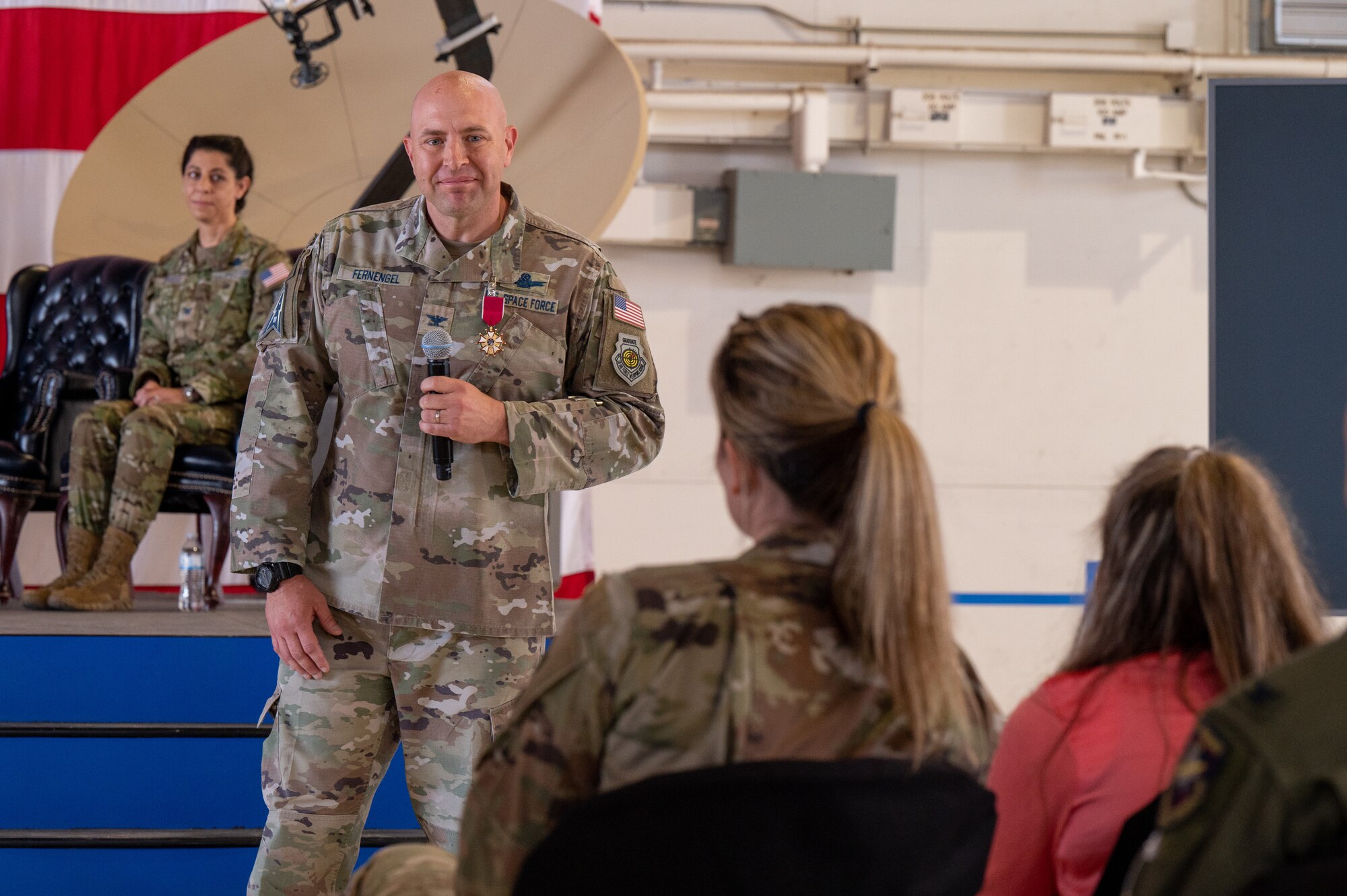 U.S. Space Force Col. Christopher Fernengel, outgoing Space Delta 3 commander, smiles at his wife and daughter during the DEL 3 change of command ceremony June 29, 2023, at Peterson Space Force Base. (U.S. Space Force photo by Airman 1st Class Cody Friend)