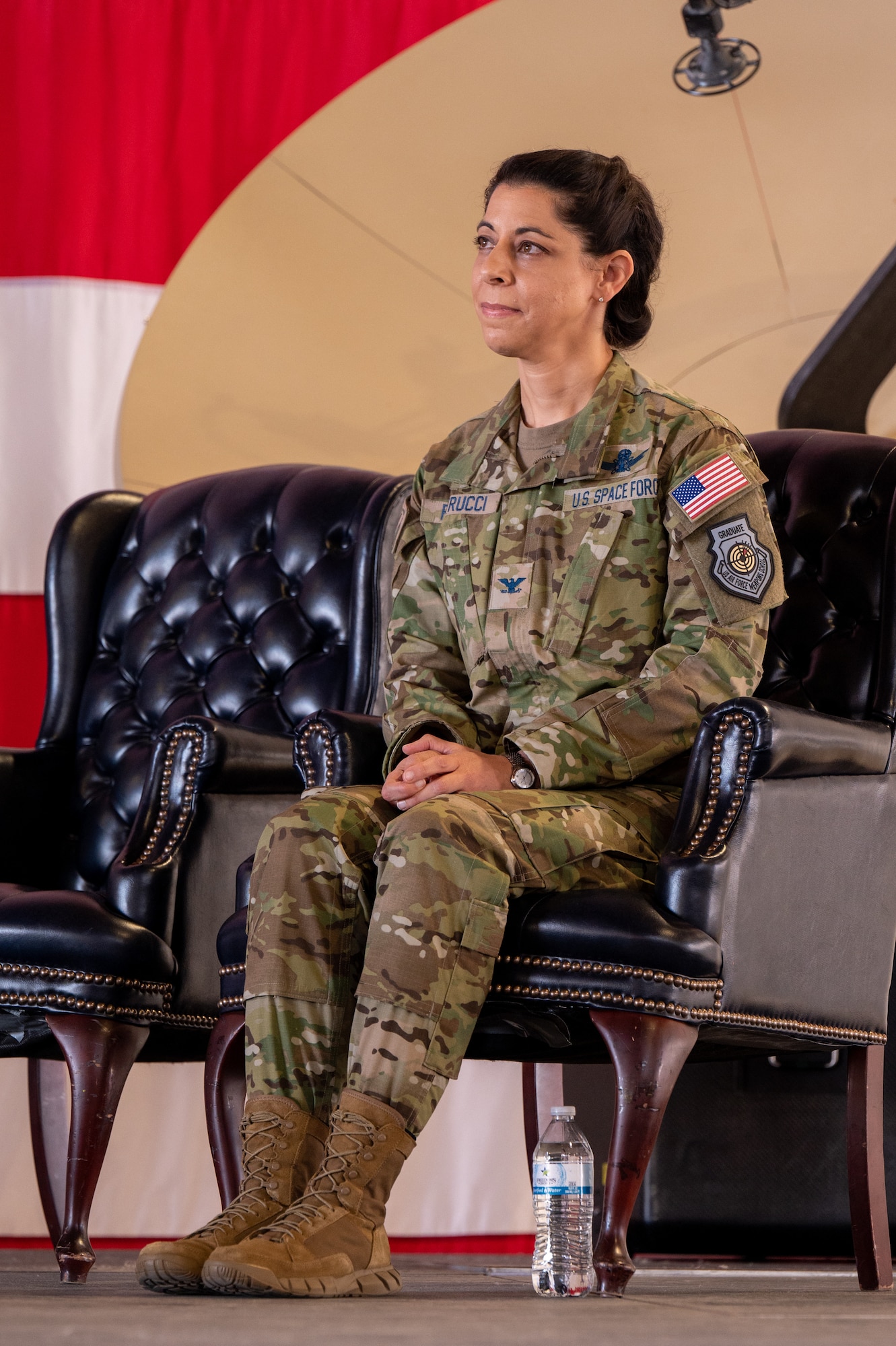 U.S. Space Force Col. Nicole Petrucci, incoming Space Delta 3 commander, sits on stage during the DEL 3 change of command ceremony June 29, 2023, at Peterson Space Force Base. DEL 3 trains and presents operational combat-ready space electromagnetic warfare forces in support of assigned missions (U.S. Space Force photo by Airman 1st Class Cody Friend)