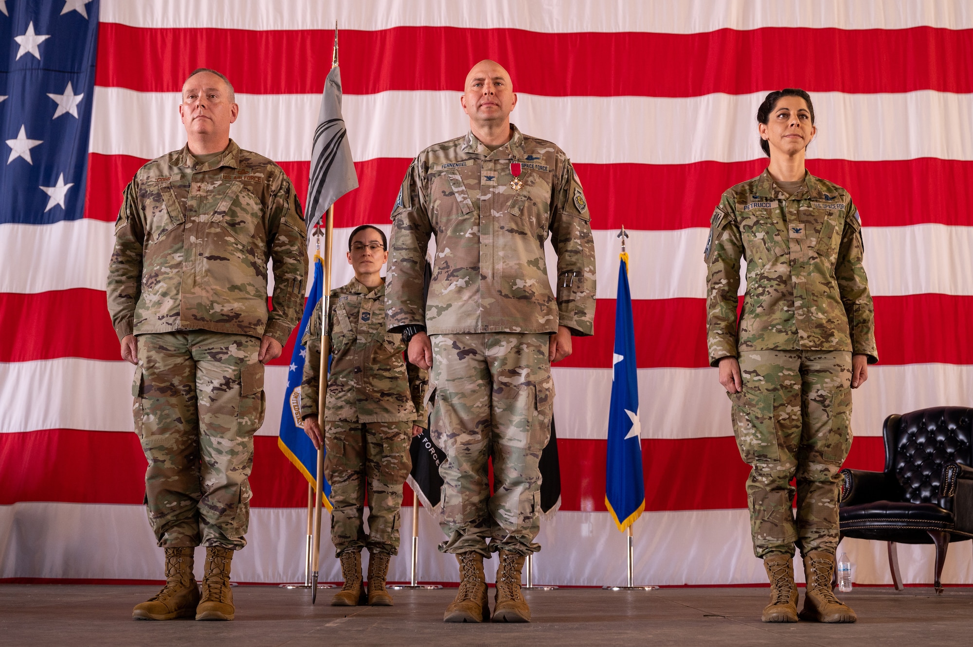 From the left, U.S. Air Force Maj. Gen. Patrick Cobb, Air National Guard Assistant to the Commander, U.S. Space Operations Command, U.S. Space Force Col. Christopher Fernengel, outgoing Space Delta 3 commander, and Col. Nicole Petrucci, incoming DEL 3 commander, stand at attention during the DEL 3 change of command ceremony June 29, 2023, at Peterson Space Force Base. DEL 3 trains and presents operational combat-ready space electromagnetic warfare forces in support of assigned missions. (U.S. Space Force photo by Airman 1st Class Cody Friend)