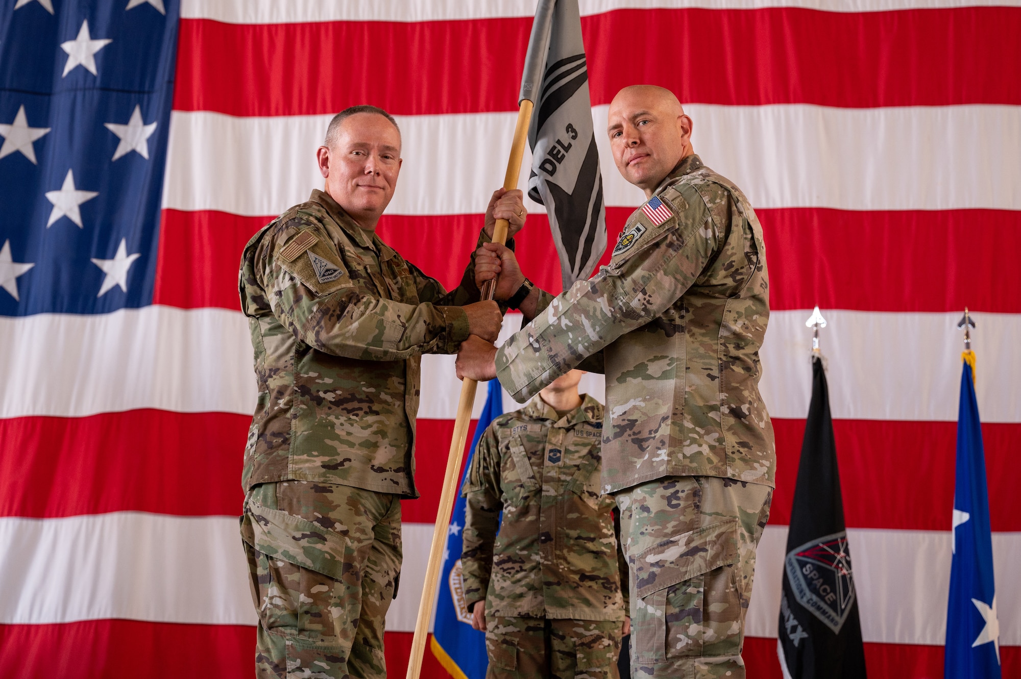 U.S. Air Force Maj. Gen. Patrick Cobb, Air National Guard Assistant to the Commander, U.S. Space Operations Command, (left) takes the Space Delta 3 guidon from U.S. Space Force Col. Christopher Fernengel, outgoing DEL 3 commander, (right) June 29, 2023, at Peterson Space Force Base. . DEL 3 trains and presents operational combat-ready space electromagnetic warfare forces in support of assigned missions. (U.S. Space Force photo by Airman 1st Class Cody Friend)