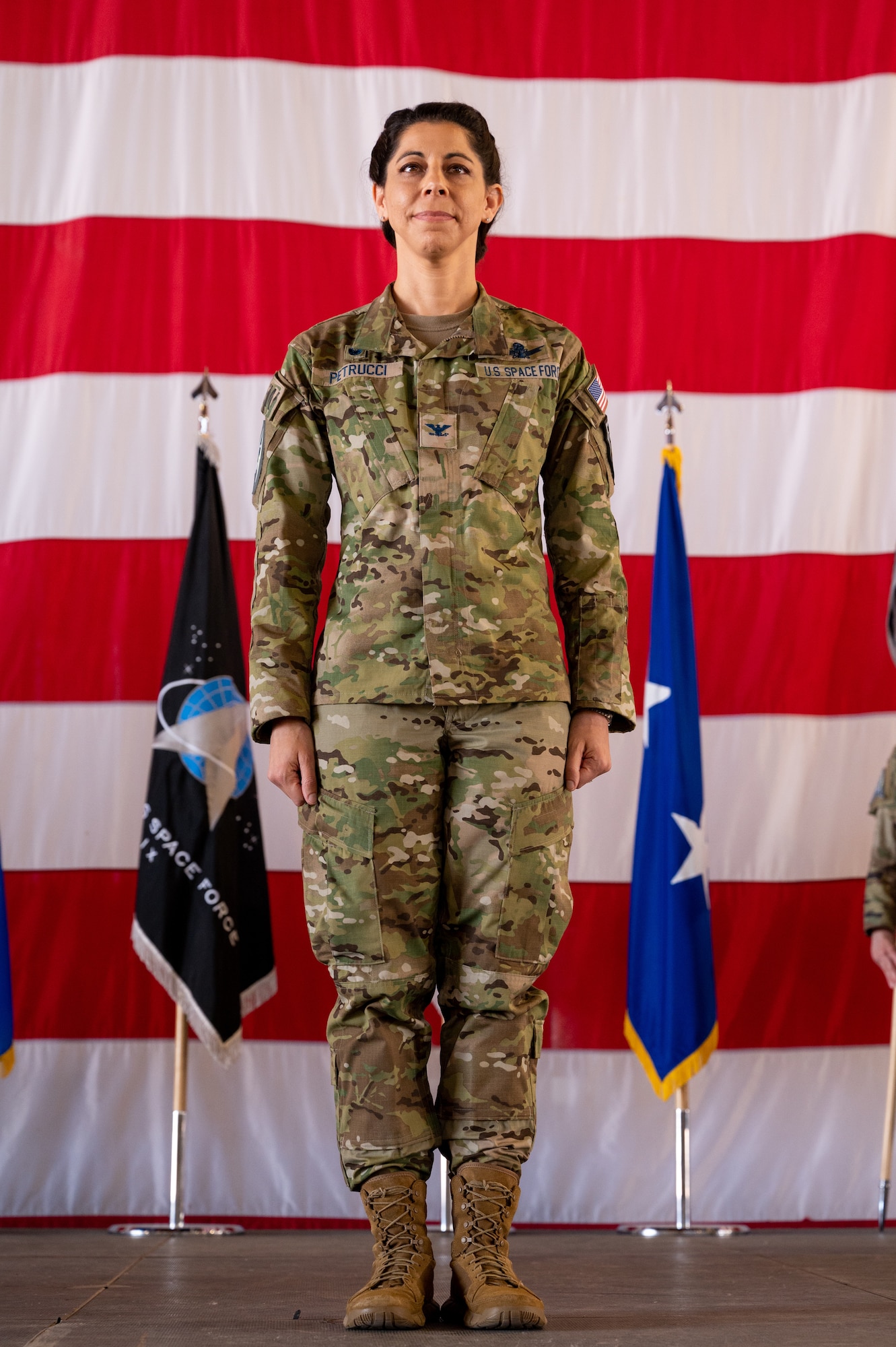 U.S. Space Force Col. Nicole Petrucci, commander, Delta 3-Space Electromagnetic Warfare, stands at attention during the DEL 3 change of command ceremony June 29, 2023, at Peterson Space Force Base. DEL 3 trains and presents operational combat-ready space electromagnetic warfare forces in support of assigned missions. (U.S. Space Force photo by Airman 1st Class Cody Friend)