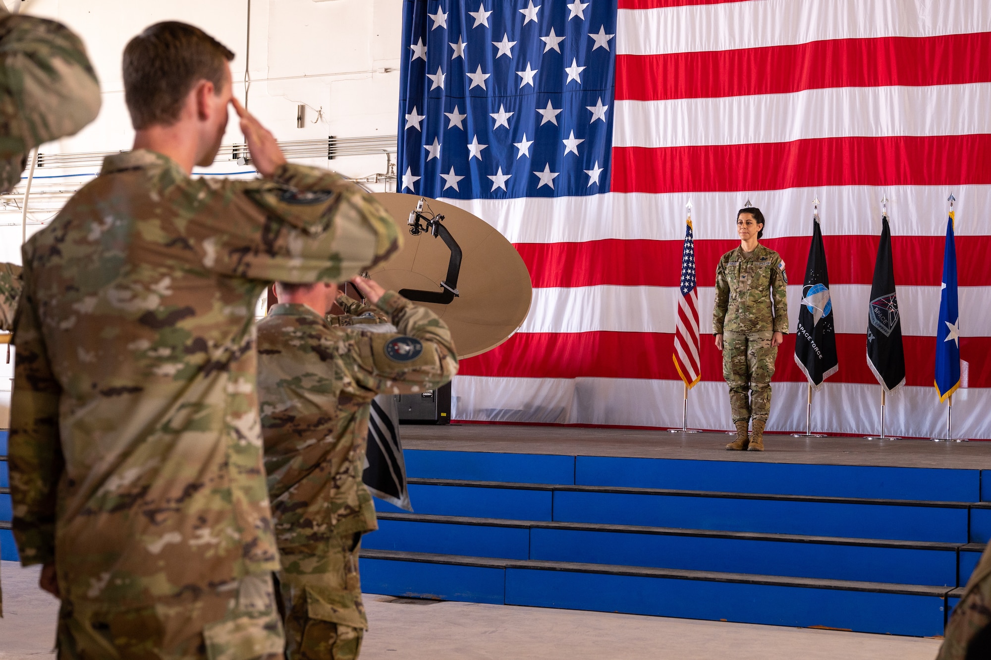 U.S. Space Force Col. Nicole Petrucci, commander, Delta 3-Space Electromagnetic Warfare, stands at attention while receiving her first salute as commander of DEL 3 at Peterson Space Force Base, Colorado on June 29, 2023. DEL 3 operates electronic attack, protection, and support capabilities to protect and defend the space domain. (U.S. Space Force photo by Airman 1st Class Cody Friend)