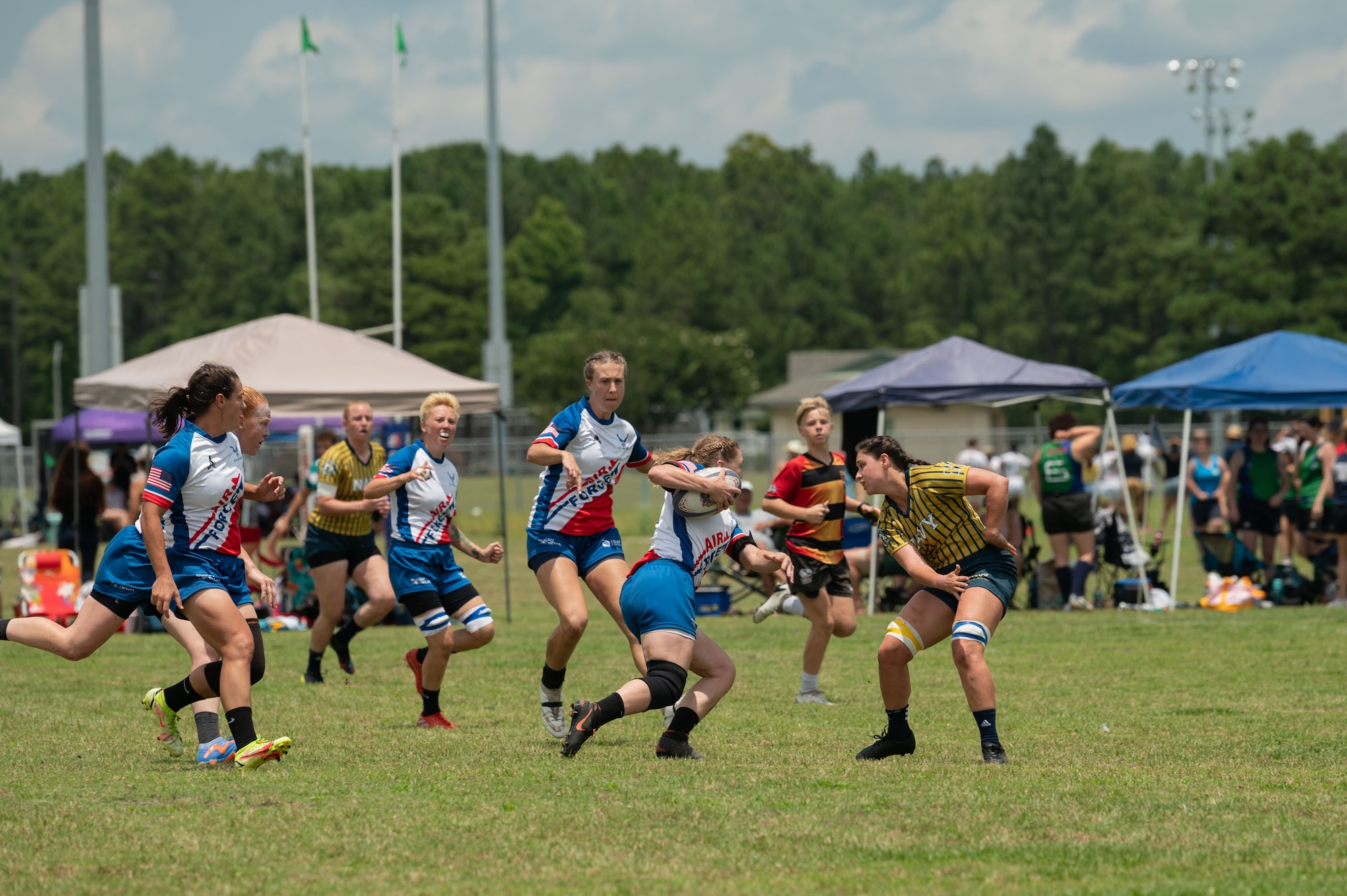 The U.S. Air Force and Space Force Women’s Rugby players run the ball during a rugby match against the United States Coast Guard at the Annual Armed Forces Women’s Rugby Championship in Wilmington, North Carolina, June 24, 2023. The Air and Space Force competed against teams from other branches of services ultimately winning the championship. (U.S. Air Force photo by Airman 1st Class Rebecca Sirimarco-Lang)