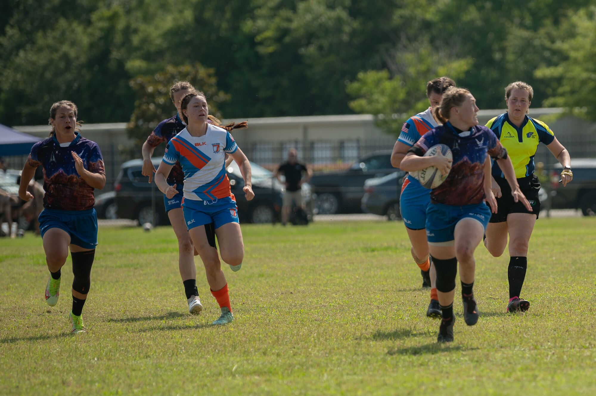 Members of the U.S. Air Force and Space Force and the U.S. Coast Guard Women’s Rugby Teams run towards the goal at the Annual Armed Forces Women’s Rugby Championship in Wilmington, North Carolina, June 24, 2023. The joint competition included athletes from each branch of the Department of Defense to promote fitness and camaraderie. (U.S. Air Force photo by Airman 1st Class Rebecca Sirimarco-Lang)