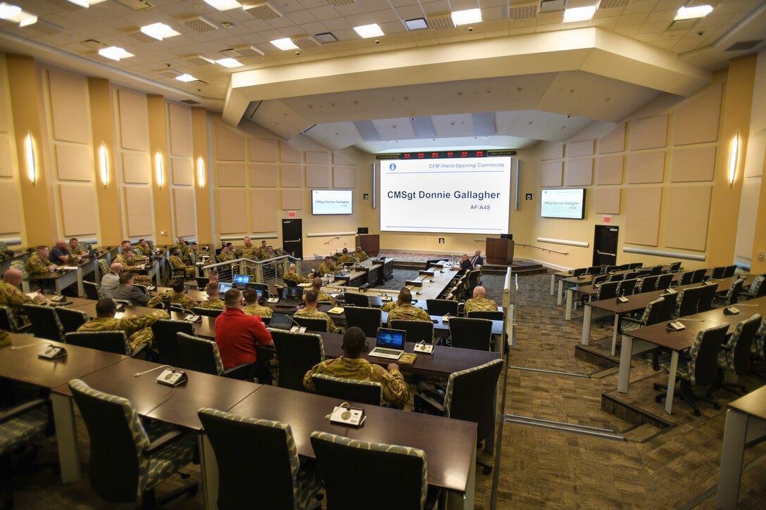 People sitting in a large room during a briefing.
