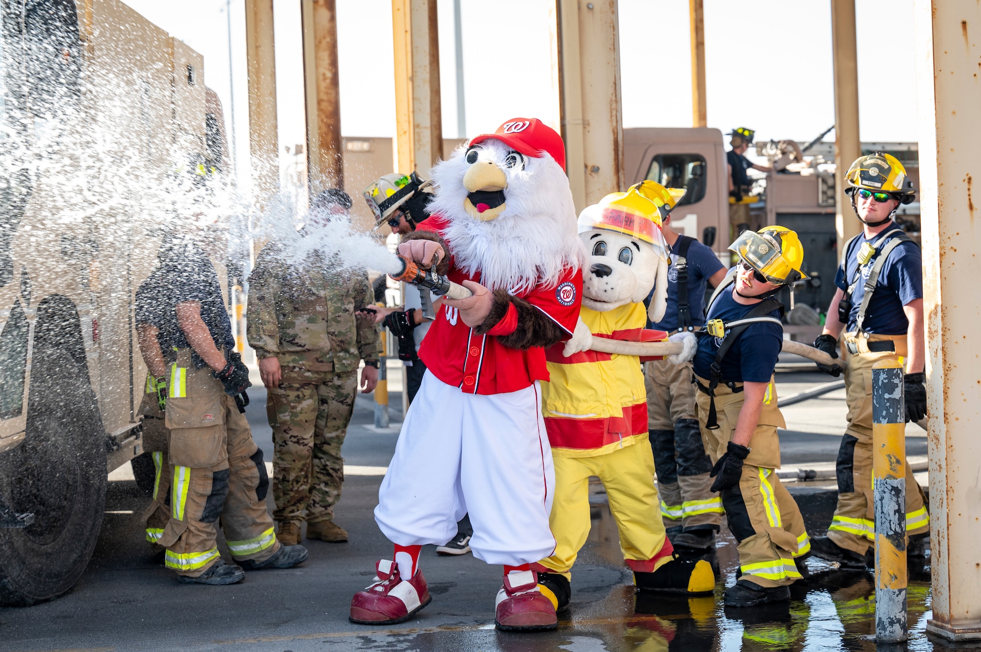 Firefighters spraying a hose