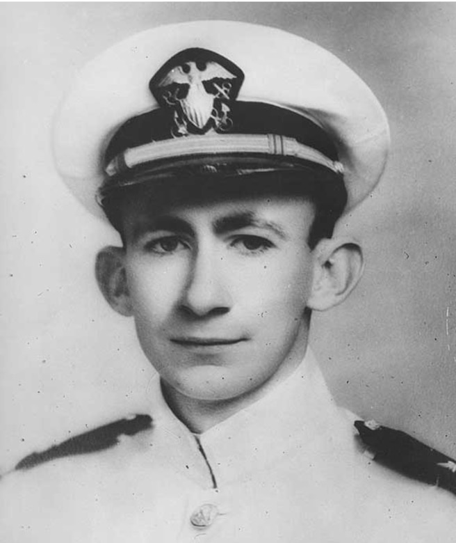 A man with a white cap and uniform poses for a photo.
