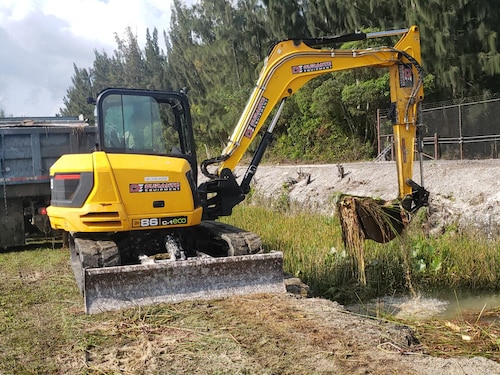 a person operates an excavator