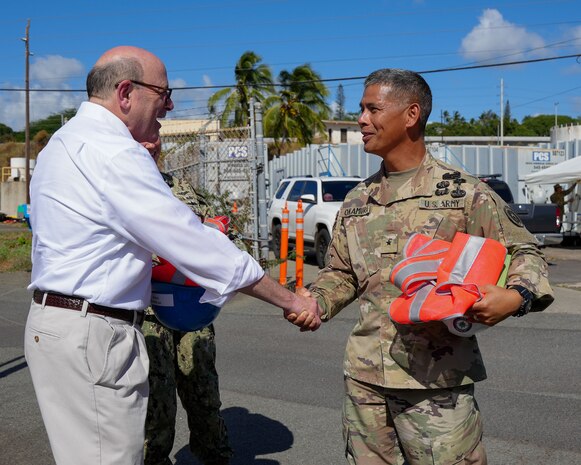 Joint Task Force-Red Hill (JTF-RH) Director of Strategic Engagement, U.S. Army Brig. Gen. Lance Okamura, right, shakes hands with Department of Defense Inspector General Robert Storch, left, during a tour of the Red Hill Bulk Fuel Storage Facility (RHBFSF), Halawa, Hawaii, June 27, 2023.