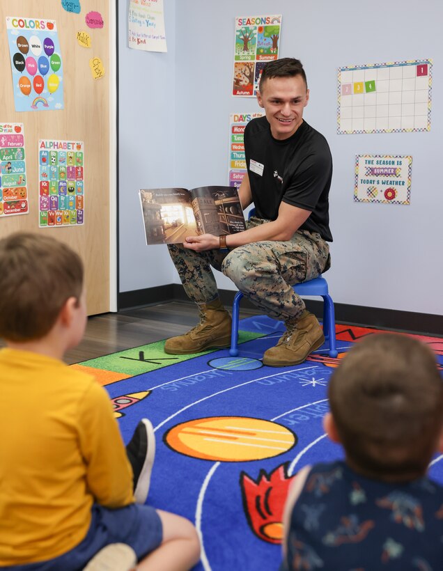 U.S. Marine Corps Cpl. Reynaldo Ornelas, an enhanced marketing vehicle noncommissioned officer at 4th Marine Corps District, reads and interacts to children at The Goddard School in Carlisle, Pennsylvania, June 29, 2023. Marines visited the daycare and preschool for community outreach and to create a Marine Corps presence. (U.S. Marine Corps photo by Cpl. Bernadette Pacheco)