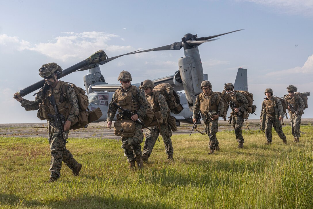 U.S. Marines with 2d Battalion, 6th Marine Regiment, 2d Marine Division, exit an MV-22 Osprey after being air-inserted during exercise Mjolnir Strike on Atlantic Airfield, North Carolina, June 27, 2023. Exercise Mjolnir Strike 3-23 is a fire support-focused training opportunity for Joint Terminal Attack Controllers and Joint  Fires Observers across II MEF to increase proficiency while incorporating multiple fire support capabilities, such as ground-based indirect fires and close air support. (U.S. Marine Corps photo by Cpl. Megan Ozaki)