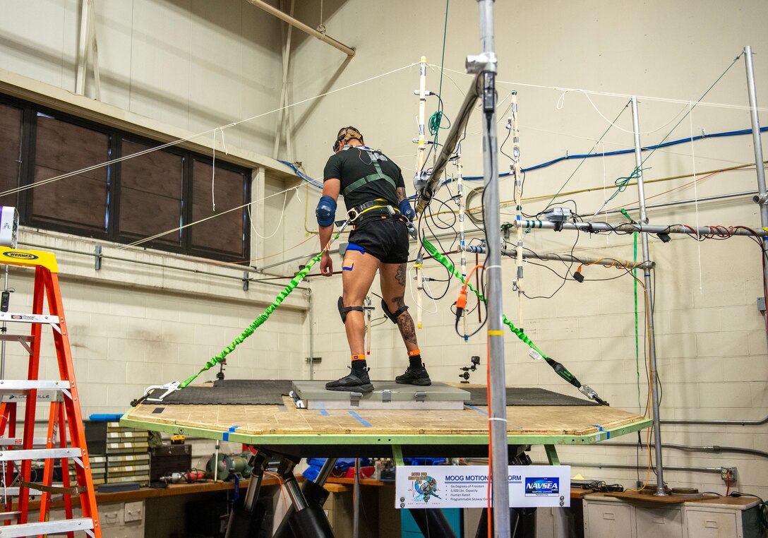 A U.S. Coast Guard Test Participant is free standing on a Moog 6DOF motion simulator while being exposed to simulated Sea State III conditions, May 23. The test was divided into two Phases, with and without a representative high speed craft standing bolster. Many high speed craft still rely on operators to stand and use their legs as shock absorbers. (U.S. Navy photo by Ronnie Newsome)