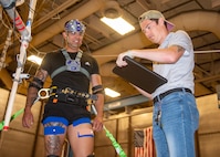 (right) Blake Draut, Naval Surface Warfare Center Panama City Division E42, interviews a U.S. Coast Guard test participant following motion exposure testing, May 23. Several surveys are administered to the tester throughout the process including immediately after donning the Accelo-Suit, verbal interview while still on the platform and a more in-depth interview at completion of a subject’s participation. (U.S. Navy photo by Ronnie Newsome)