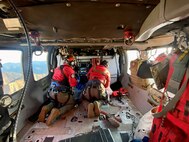 Naval Air Station Whidbey Island Search and Rescue medical personnel attend to an injured speed-flyer who had crashed on Church Mountain, Wash. July 3, 2023.