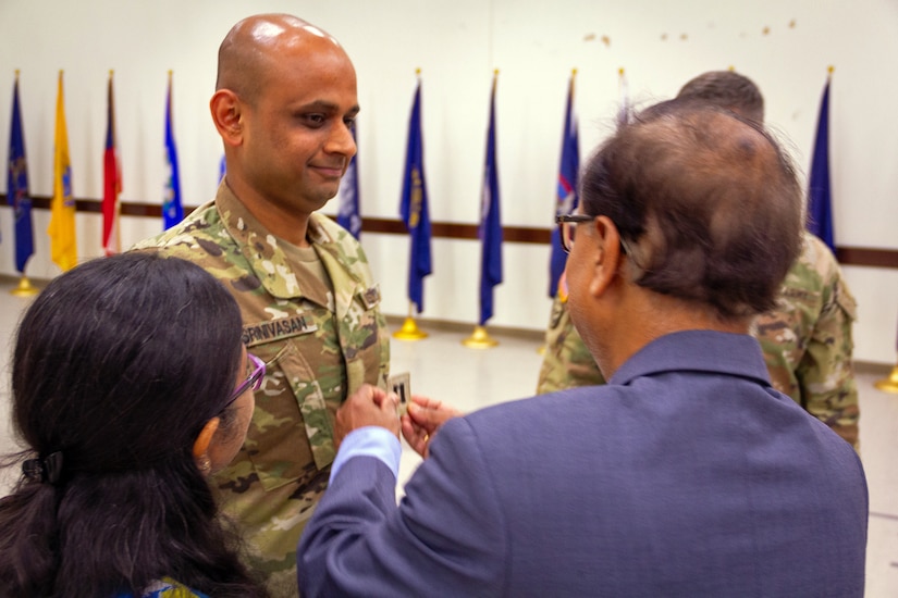 Venkatesh Srinivasan receives the rank of captain and is pinned his rank by his father during his commissioning ceremony at Joint Reserve Base Ellington, Texas on June 25, 2023. Srinivasan joined the Army Reserve in October 2015 and worked tirelessly to receive a direct commission as an officer at the rank of captain. (U.S. Army photo by Maj. Charles An, U.S. Army Reserve Innovation Command)