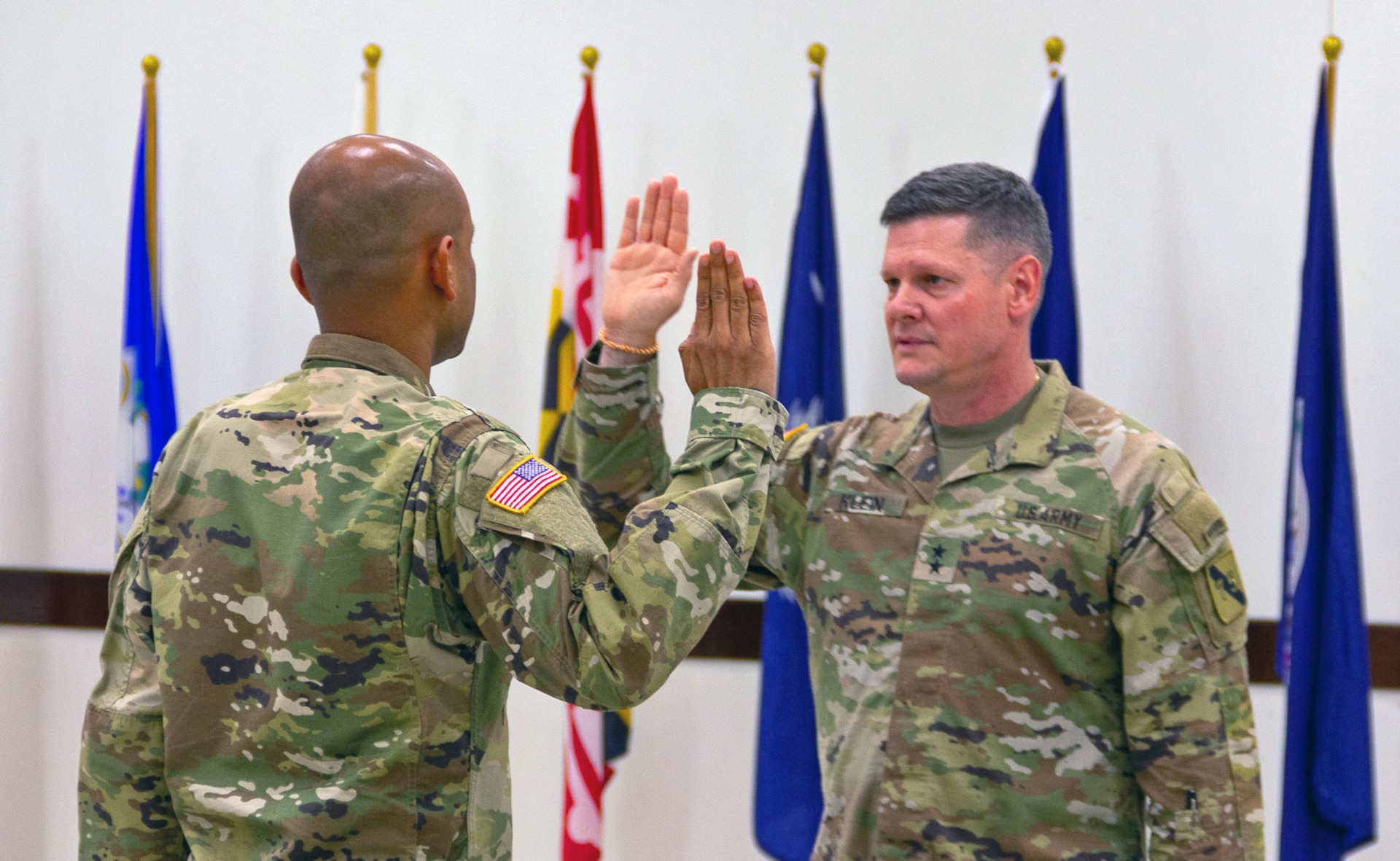 Captain Venkatesh Srinivasan, left, repeats the Oath of Office after Maj. Gen. Martin Klein, commanding general, U.S. Army Reserve Innovation Command, during Srinivasan’s commissioning ceremony at Joint Reserve Base Ellington, Texas on June 25, 2023. Srinivasan joined the Army Reserve in October 2015 and worked tirelessly to receive a direct commission as an officer at the rank of captain. (U.S. Army photo by Maj. Charles An, U.S. Army Reserve Innovation Command)