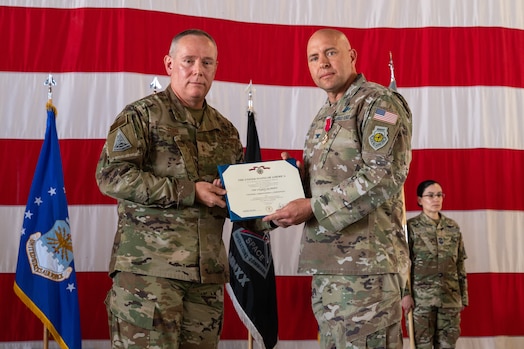  U.S. Air Force Maj. Gen. Patrick Cobb, Air National Guard Assistant to the Commander, Space Operations Command, (left) presents U.S. Space Force Col. Christopher Fernengel, outgoing Space Delta 3 commander, (right) with the Legion of Merit during DEL 3’s change of command ceremony June 29, 2023, at Peterson Space Force Base. The Legion of Merit was given to Fernengel for exceptionally meritorious conduct in the performance of outstanding service to the U.S. as commander of DEL 3. (U.S. Space Force photo by Airman 1st Class Cody Friend)