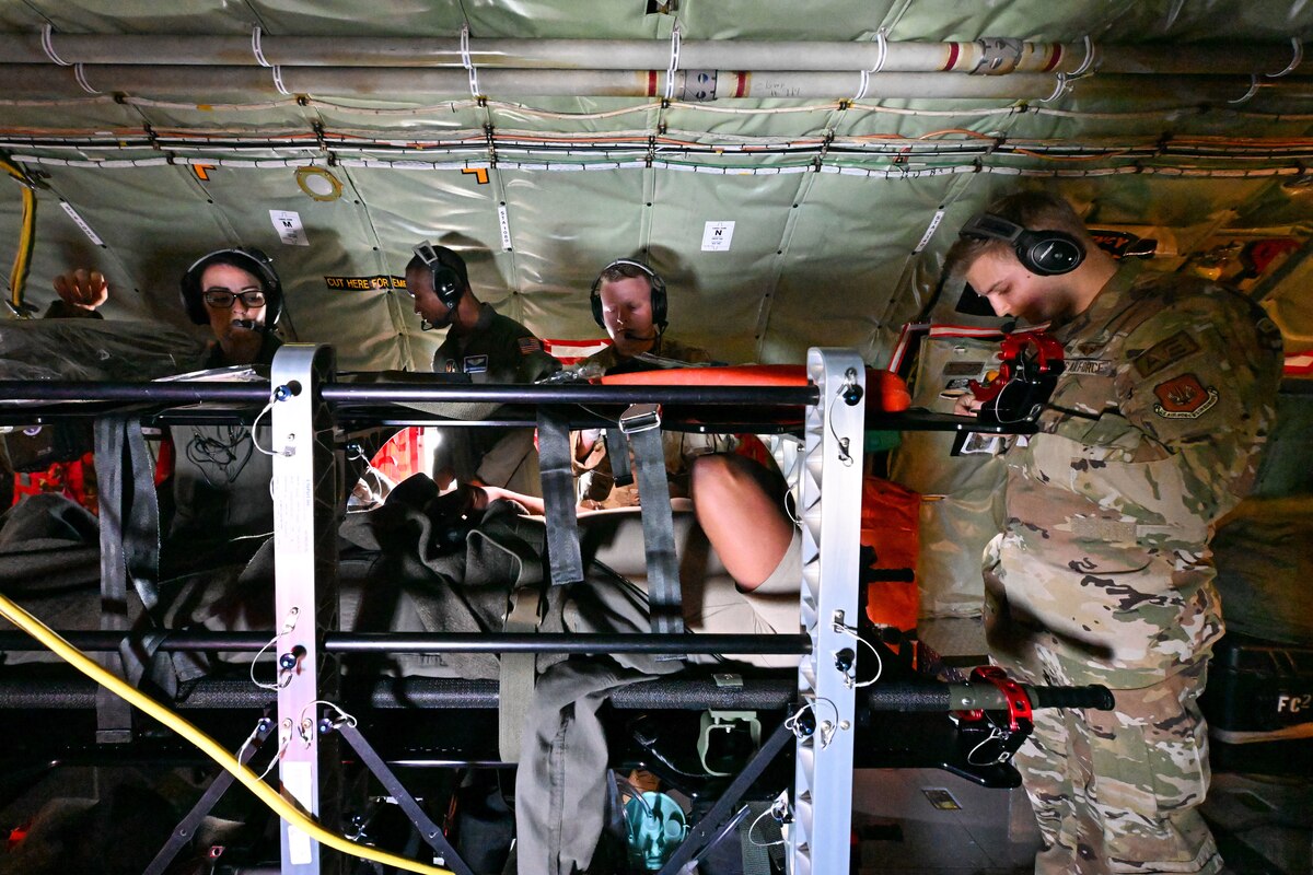Service members practice medical procedures.