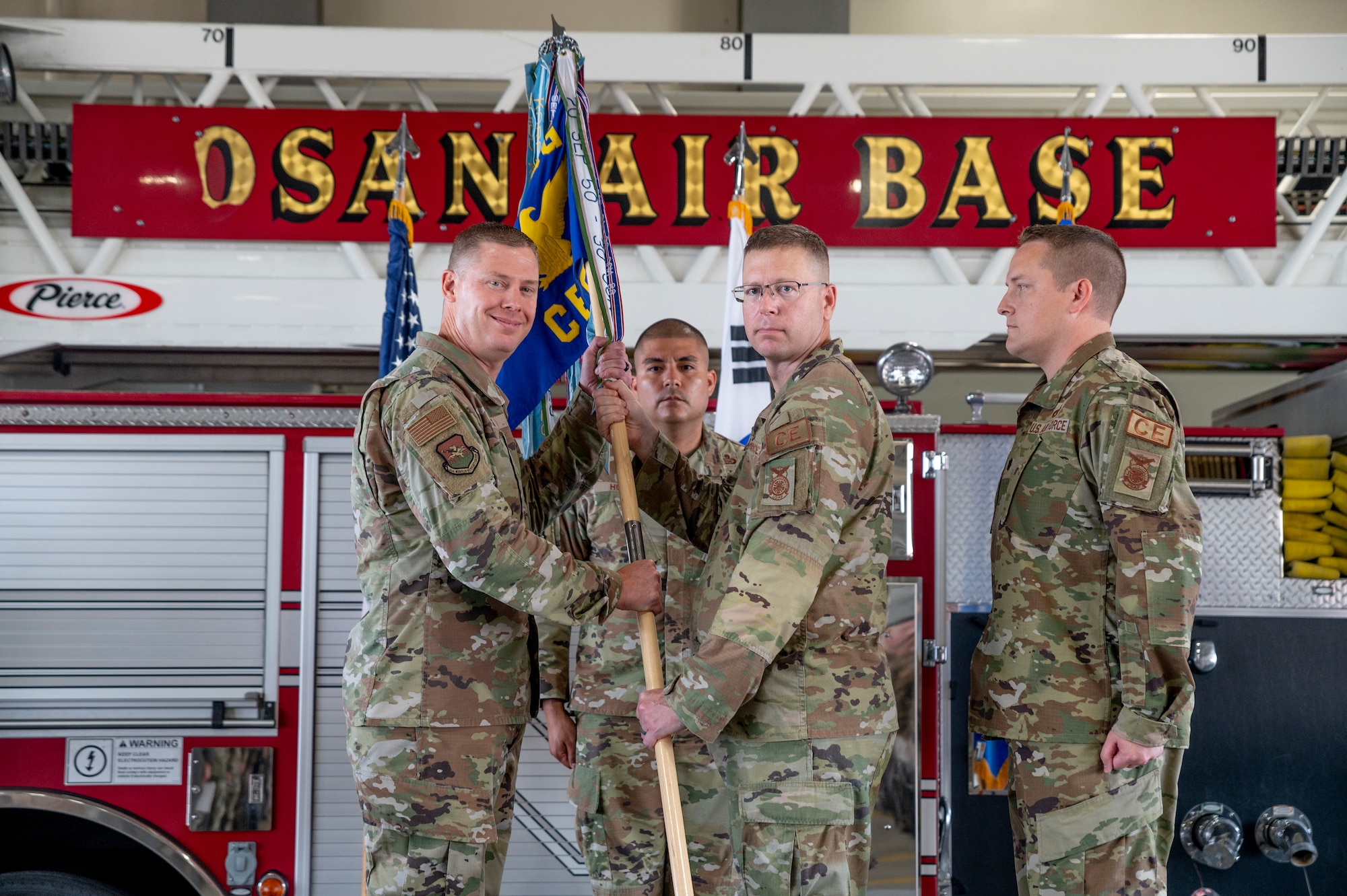 U.S. Air Force Lt. Col. Brian Low, right, 51st Civil Engineer Squadron (51st CES) outgoing commander, relinquishes command of the 51st CES to Col. Kyle Grygo, 51st Mission Support Group commander, during a change of command ceremony at Osan Air Base, Republic of Korea, July 5, 2023.