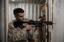 NAVAL SUPPORT ACTIVITY BAHRAIN (July 03, 2023) – A U.S. Marine assigned to Fleet Anti-terrorism Security Team Company Central (FASTCENT) provides security during close-quarters battle training at the U.S. Coast Guard Patrol Forces Southwest Asia Maritime Engagement Team training facility aboard Naval Support Activity Bahrain, July 03. FASTCENT provides expeditionary anti-terrorism and security forces to embassies, consulates, and other vital national assets throughout the U.S. Central Command area of responsibility. (U.S. Marine Corps photo by Cpl. Angela Wilcox)