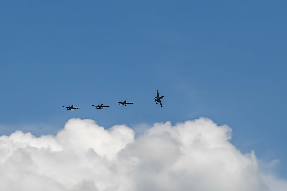 Aircraft fly in formation.