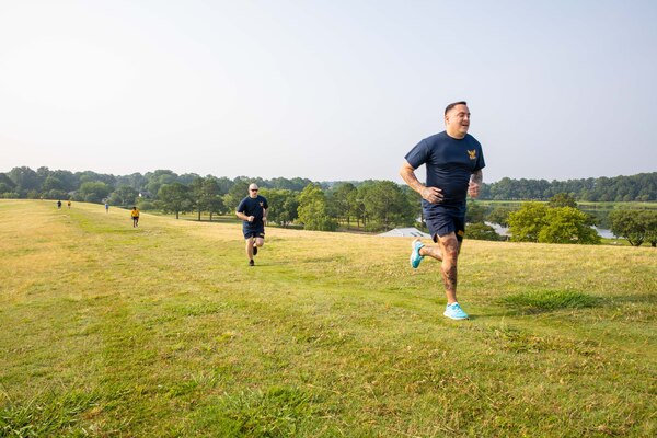 A sailor running on a grass field