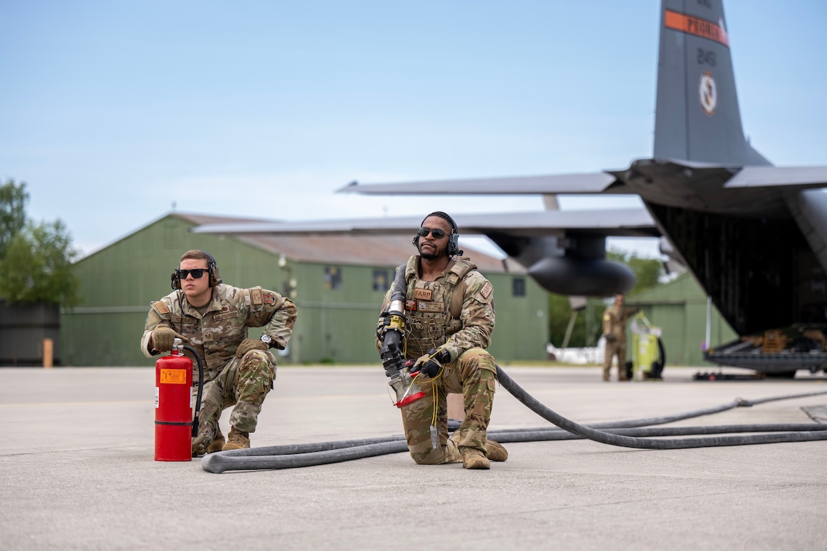 U.S. Airmen assigned to the 123rd Airlift Wing, Kentucky National Guard practice refueling operations in an austere environment, transferring fuel directly from one aircraft to another at Lechfeld Air Base, Germany, during exercise Air Defender (AD23), June 19, 2023. Exercise AD23 integrates both U.S. and allied air-power to defend shared values, while leveraging and strengthening vital partnerships to deter aggression around the world. (U.S. Air National Guard photo by Staff Sgt. Joseph R. Morgan)