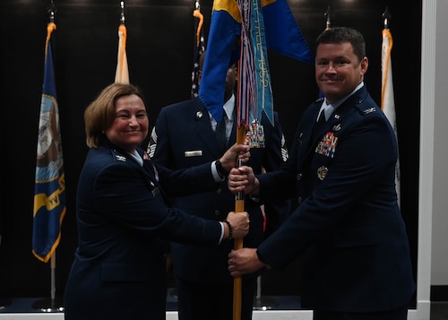 U.S. Air Force Col. Angelina Maguinness, 17th Training Wing commander, passes the guidon to Col. Timothy Dalby, 17th Mission Support Group commander, upon assuming command during the assumption of command ceremony at the Powell Event Center, Goodfellow Air Force Base, Texas, July 5, 2023. The mission of the 17th MSG is to lay the foundation for executing the training mission and taking care of service members. It maintains and continually improves the base infrastructure, provides security, and operates the wing's extensive computer architecture. (U.S. Air Force photo by Airman 1st Class Madison Collier)