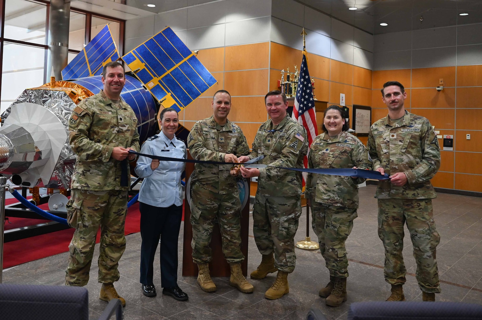 Members pose with a ribbon